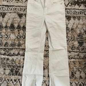 High waisted white skinny jeans with slight flare and small ankle slit